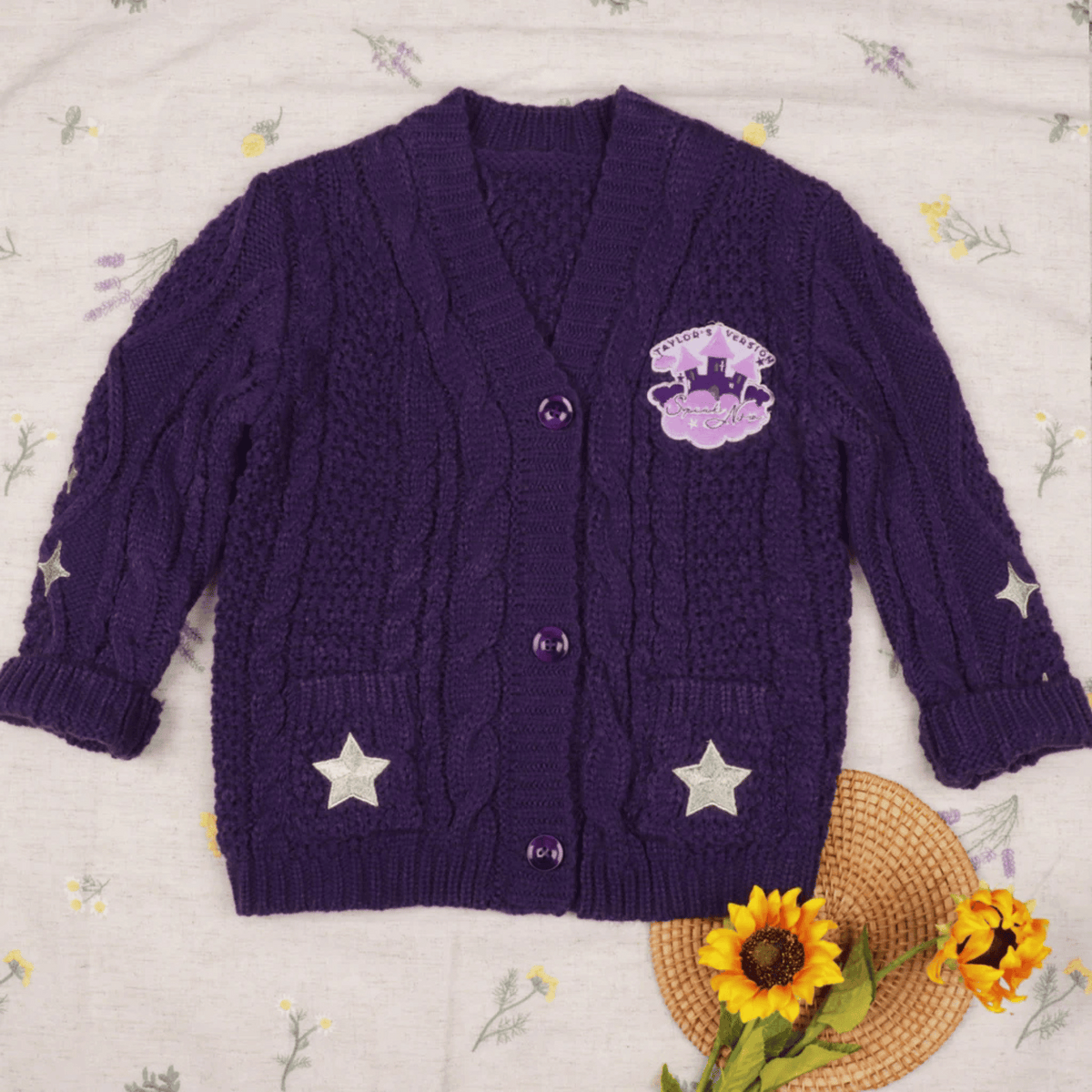 Purple cardigan with star designs on a floral background