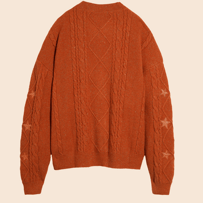 Brown cable knit sweater on a beige background