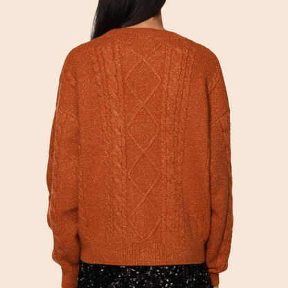 Brown knitted sweater with a geometric pattern on a beige background